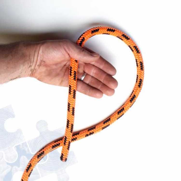 Orange rope showing first step of creating a Fishermans knot