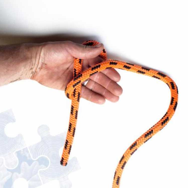 Orange rope showing second step of creating a Fishermans knot