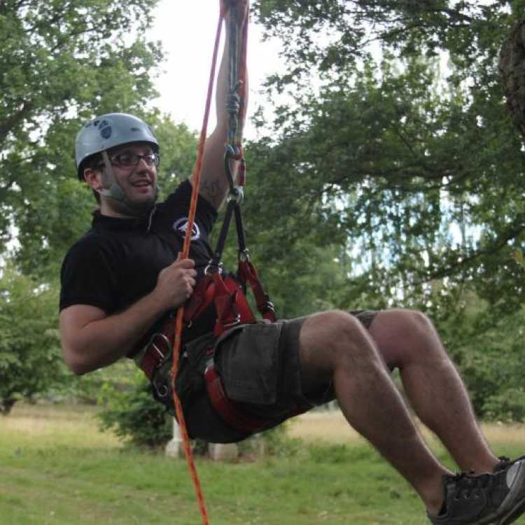 Man starting his tree climbing experience 