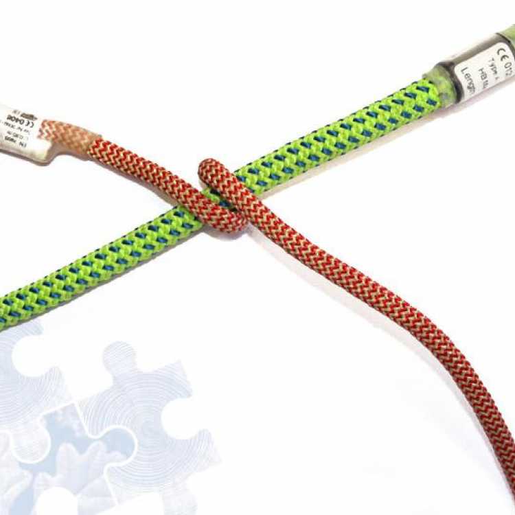Green and red rope showing second step of creating a knot 